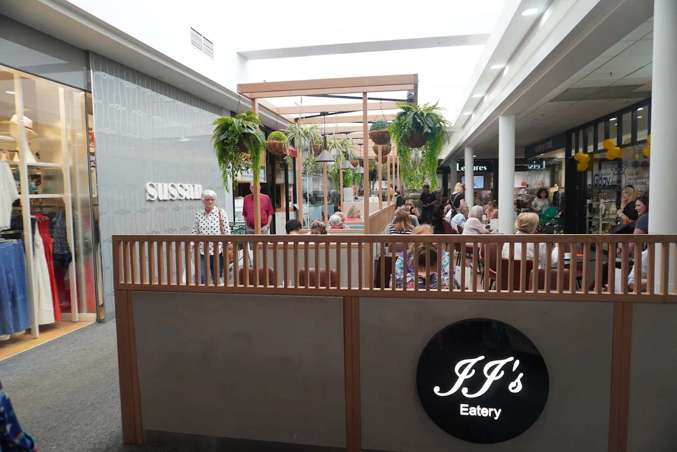 JJ's Eatery seating framed by timber and hanging plants